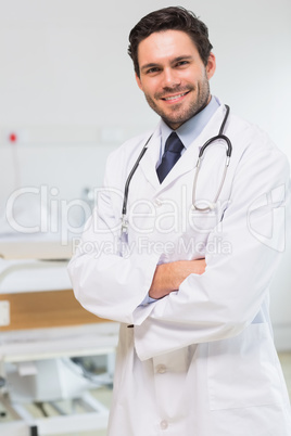 Handsome doctor standing arms crossed