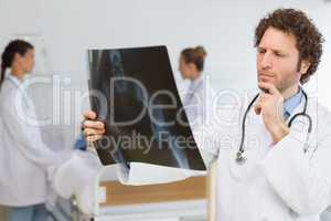 Concentrated doctor examining Xray