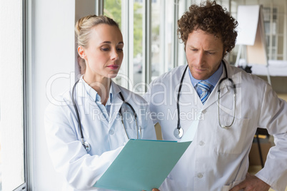 Doctors discussing over file