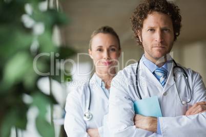 Confident doctors standing arms crossed