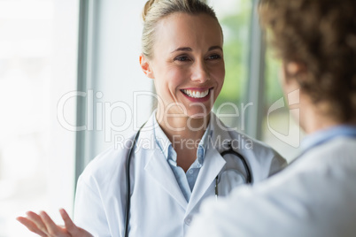Beautiful doctor discussing with colleague