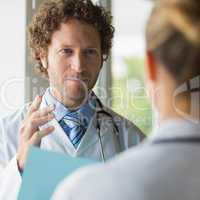 Doctor discussing with female colleague