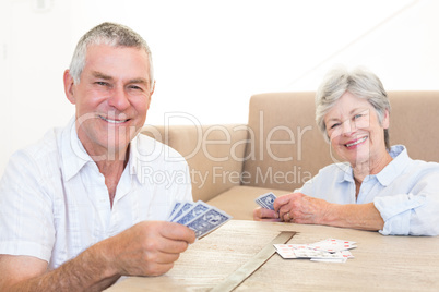 Happy couple playing cards