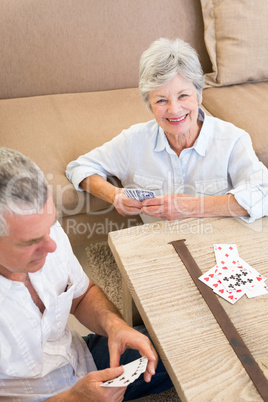 Portrait of happy woman playing card