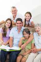 Happy multigeneration family with book