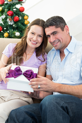 Loving couple holding Christmas present