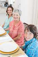 Multigeneration family sitting at dining table