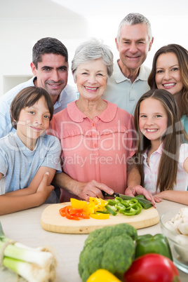 multigeneration family preparing food at counter