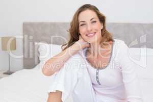 Smiling woman sitting on bed