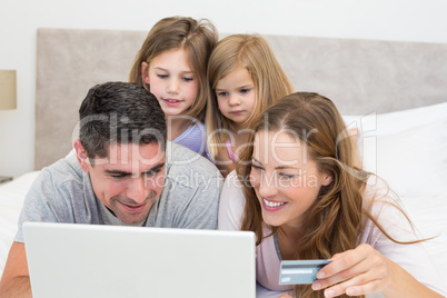 Family with credit card shopping online