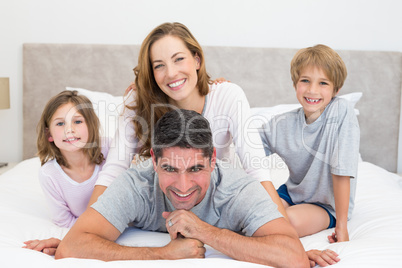 Happy children and parents in bed