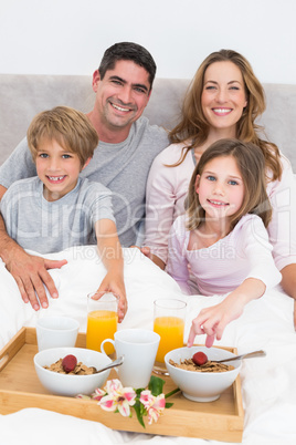 Family having breakfast in bed