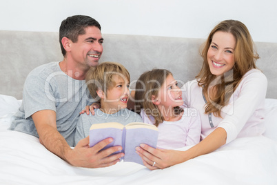 Happy woman holding storybook
