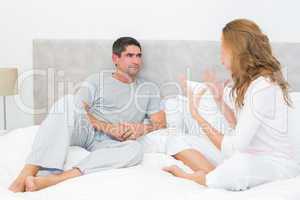 Couple arguing in bed