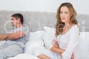 Angry woman with man in bed