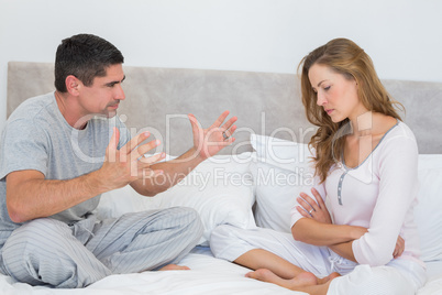 Unhappy couple in bed