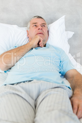 Thoughtful senior man in bed