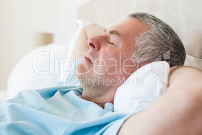 Senior man sleeping in bed