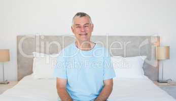 Senior man sitting on bed