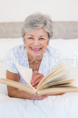 Senior woman turning story book pages