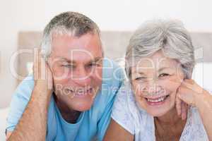 Senior couple smiling in bed