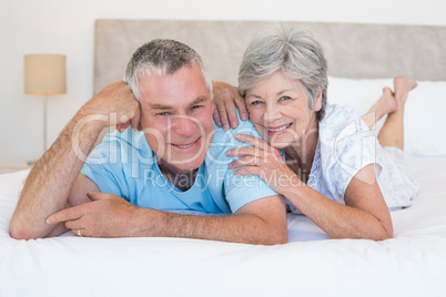 Loving senior couple lying in bed