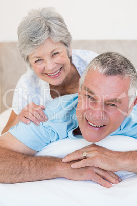 Loving senior couple relaxing in bed