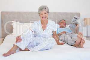 Happy senior woman with man on bed