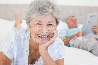 Senior woman with man in bed