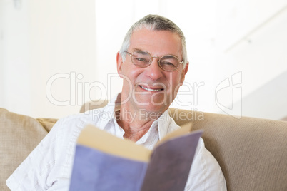 Handsome senior man with book