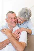 Loving senior woman embracing husband