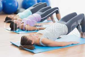 Fit class exercising at fitness studio