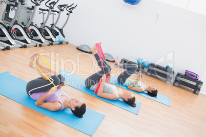 Sporty women with exercise bands in fitness studio