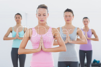 Sporty women with joined hands in fitness studio