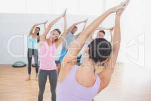 Sporty class with joined hands in fitness studio