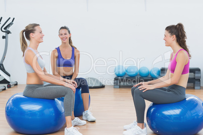 Sporty young women sitting on exercise balls