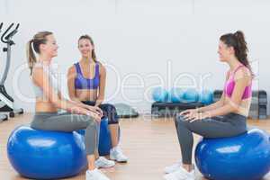 Sporty young women sitting on exercise balls