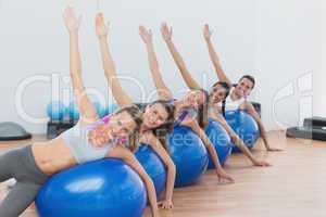 Portrait of class exercising on fitness balls