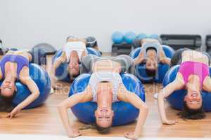 Portrait of class exercising on fitness balls