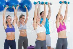 Fitness class exercising with dumbbells