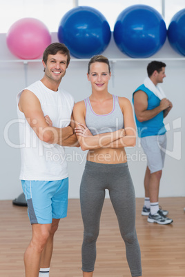 Smiling couple with a man in background