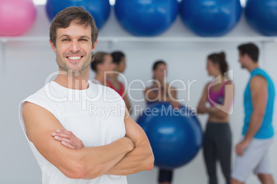 Man with friends in background at fitness studio