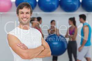 Man with friends in background at fitness studio