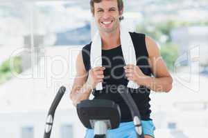 Smiling man working out at spinning class in bright gym