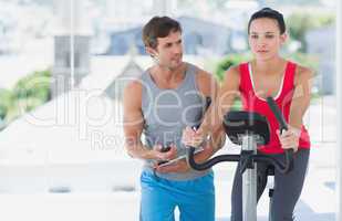 Male instructor working out at spinning class