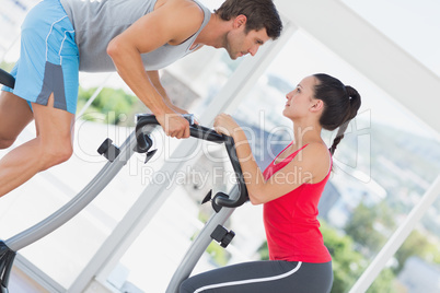 Determined couple working out at spinning class Determined couple working out at spinning class