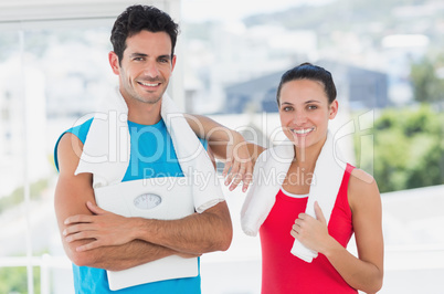 Portrait of a fit couple in bright exercise room