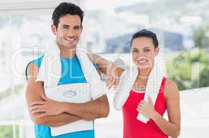 Portrait of a fit couple in bright exercise room