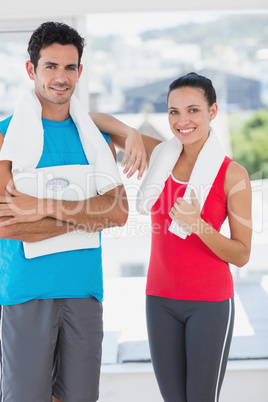 Portrait of a fit couple in bright exercise room