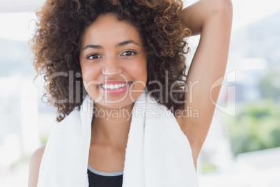 Sporty woman stretching hand behind back in fitness studio